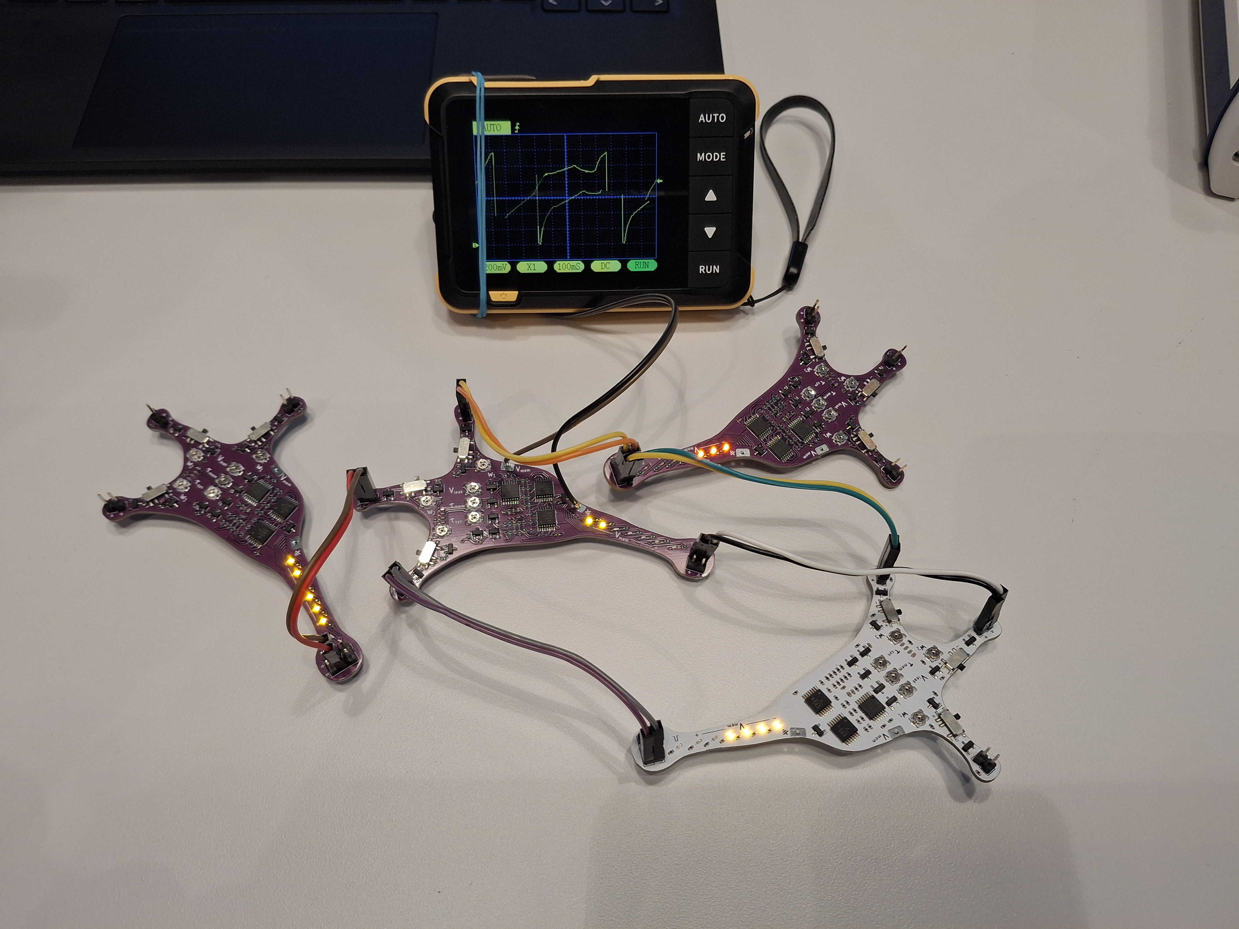 Neuron shaped PCBs with electronic components exhibiting spiking behavior